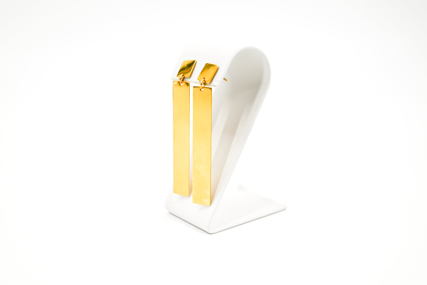 dangle gold earrings on stand