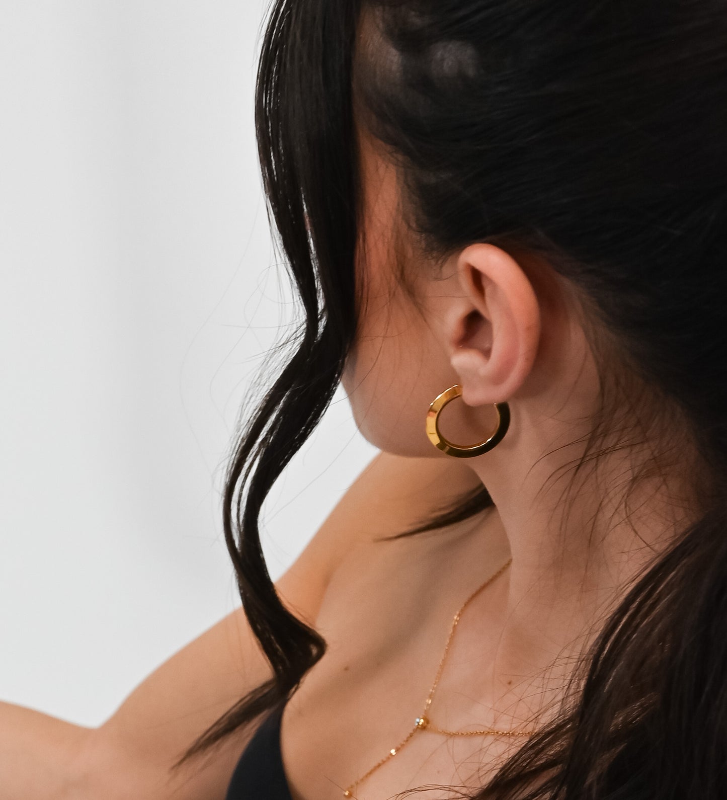 girl wearing gold hoop earrings