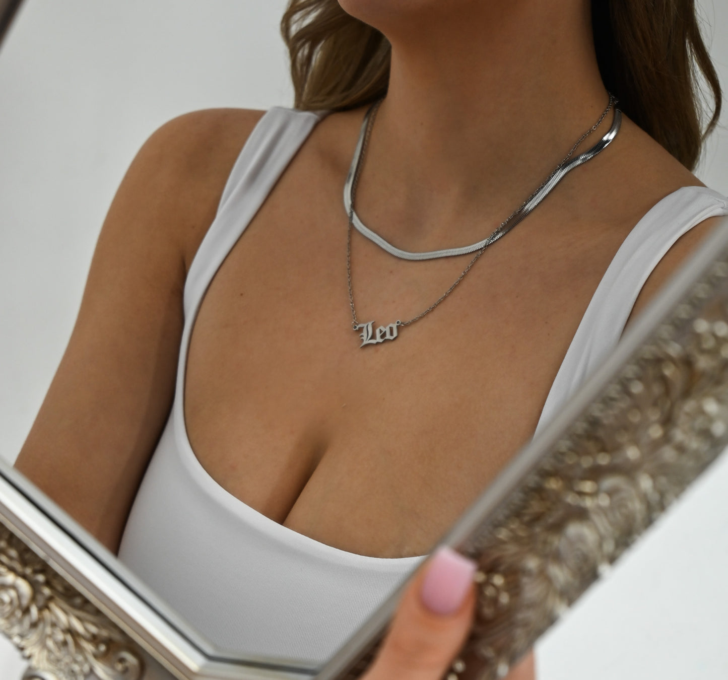 model wearing zodiac sign in gold 