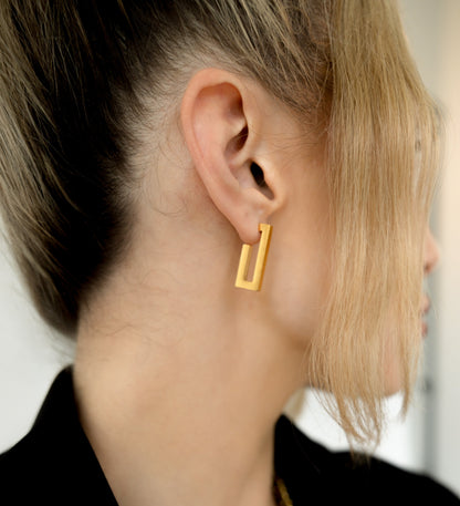 gold earrings on model 